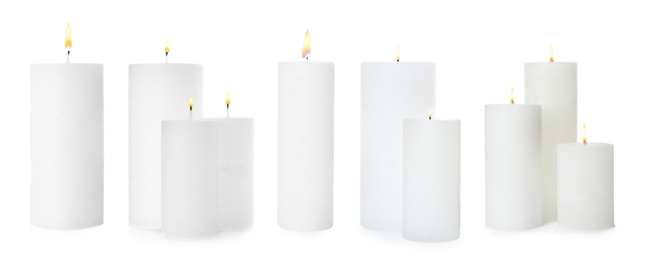 Image of Set of burning wax candles on white background. Banner design