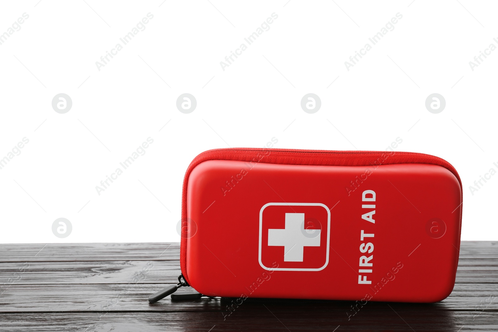 Photo of First aid kit on wooden table against white background