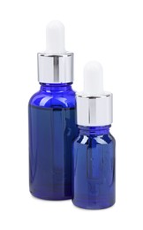 Photo of Blue bottles with tincture isolated on white