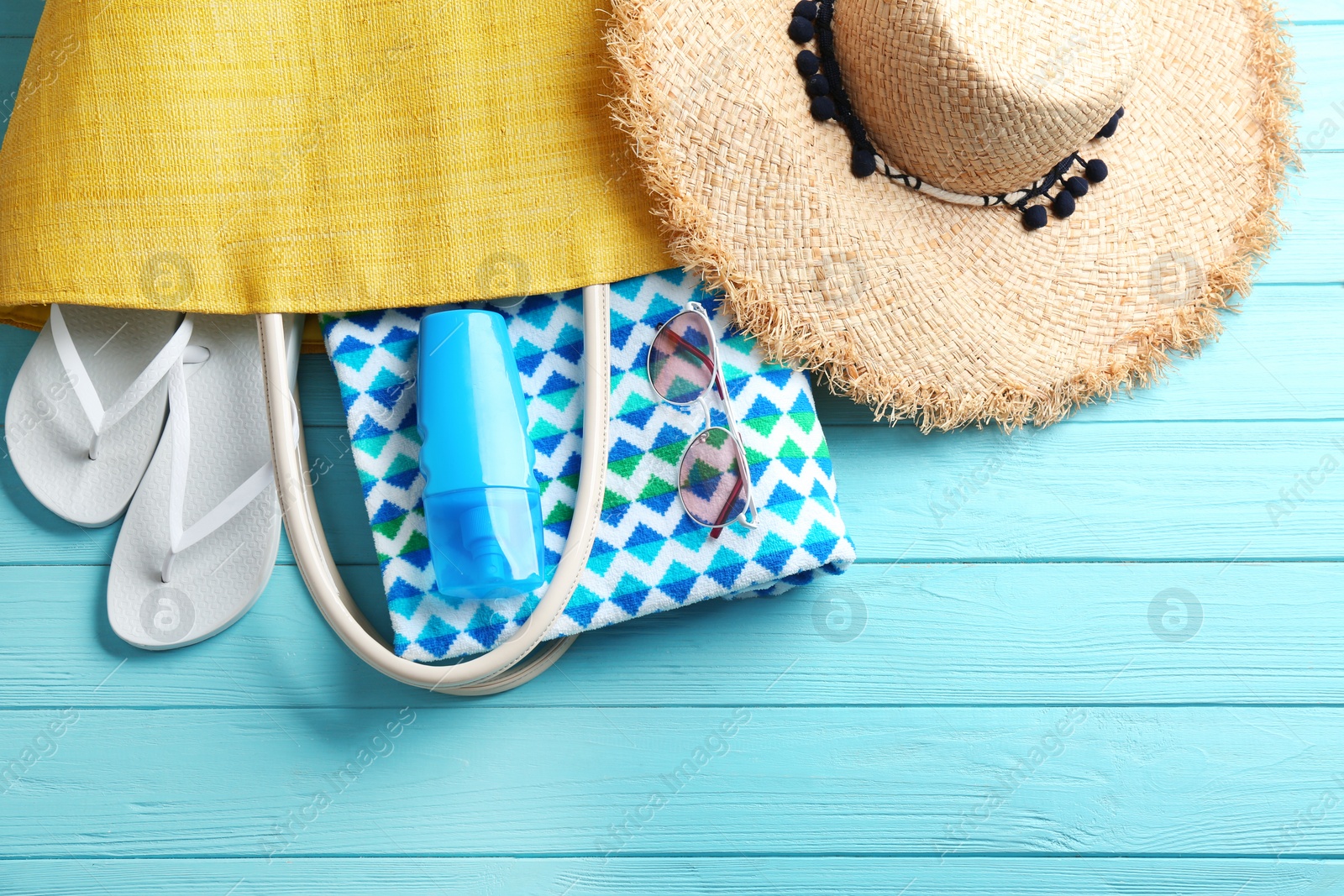 Photo of Flat lay composition with beach accessories on color wooden background. Space for text