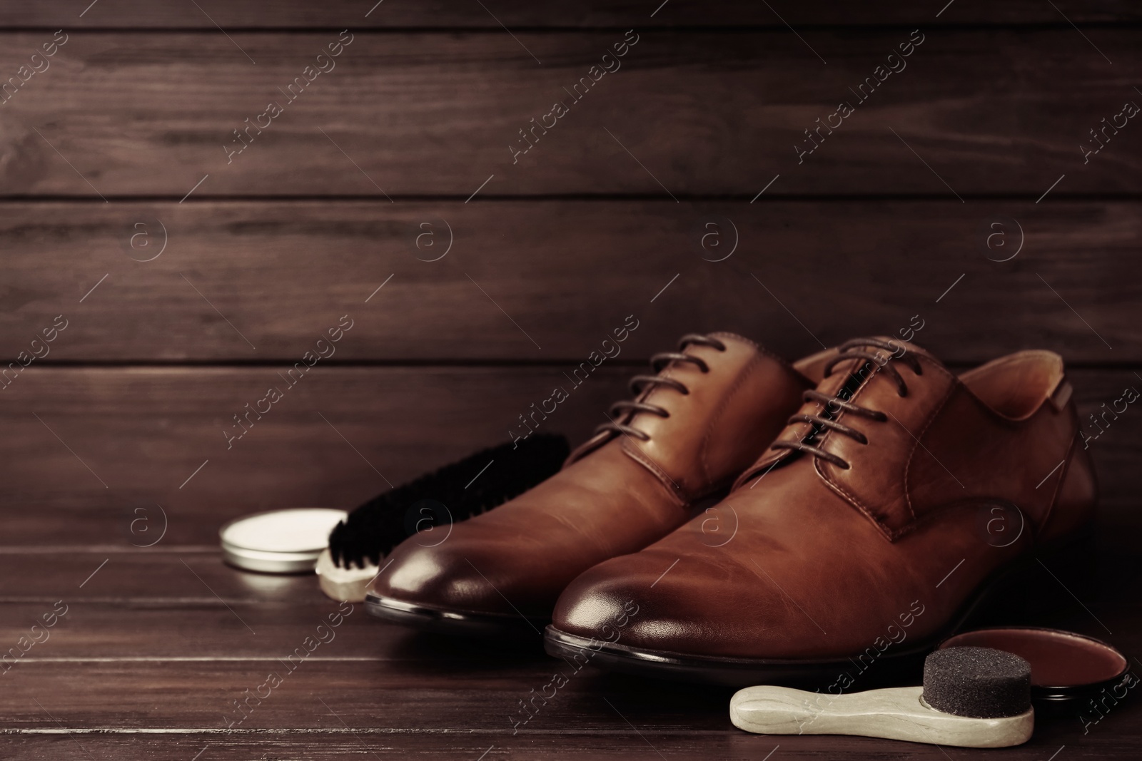 Image of Shoe care accessories and footwear on wooden background