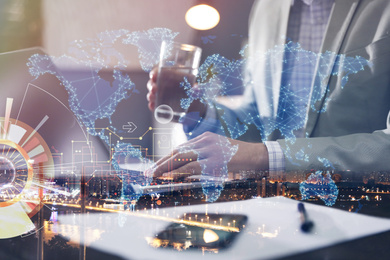 Image of Man working with laptop and night cityscape, closeup. Double exposure