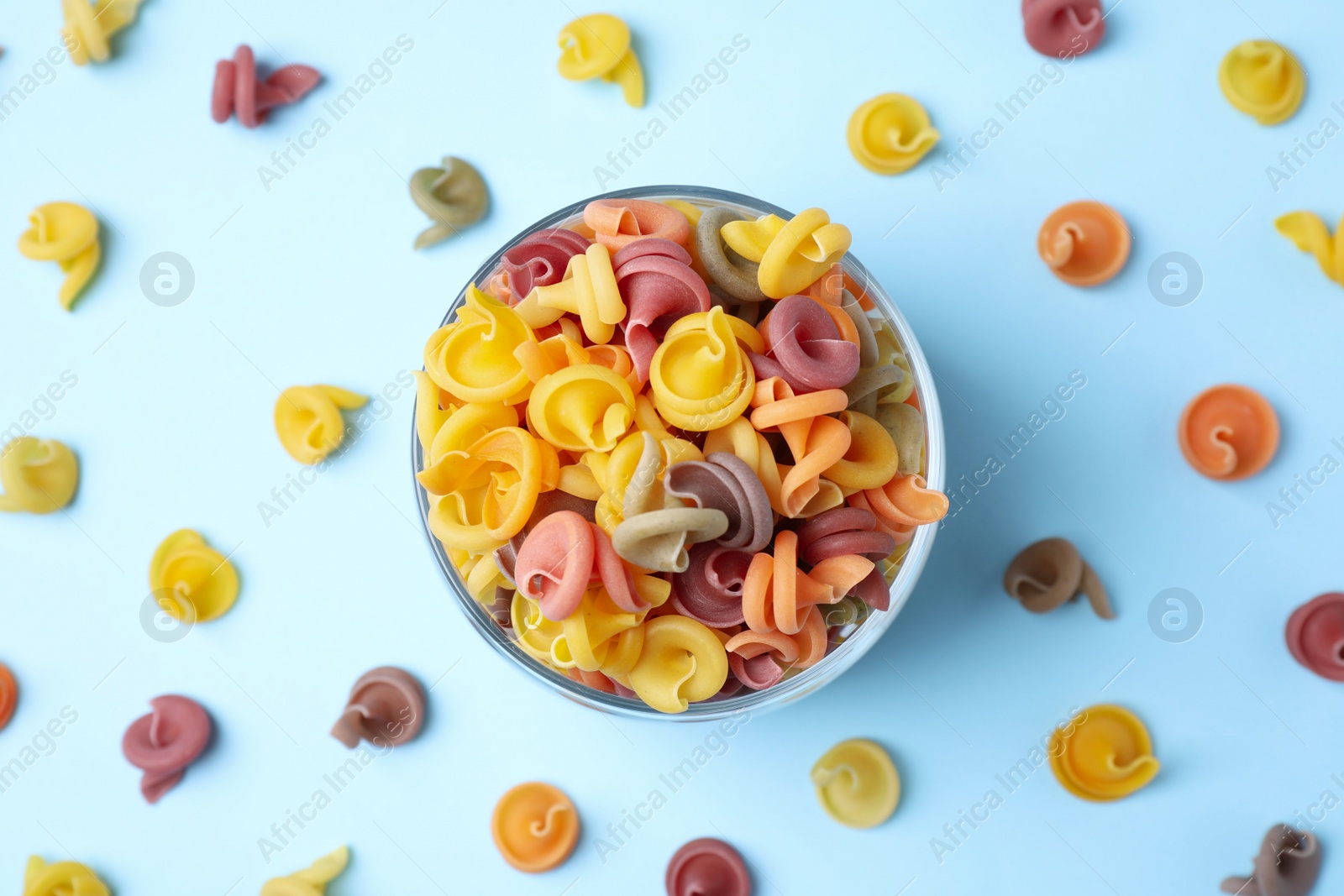 Photo of Flat lay composition with vegetable vesuvio pasta on light blue background