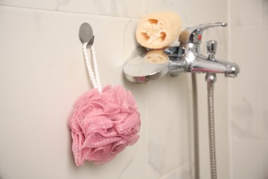 Photo of Pink shower puff and loofah sponge in bathroom