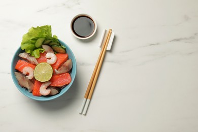 Photo of Delicious mackerel, shrimps and tuna served with lettuce, lime, cucumbers and soy sauce on white marble table, flat lay with space for text. Tasty sashimi dish