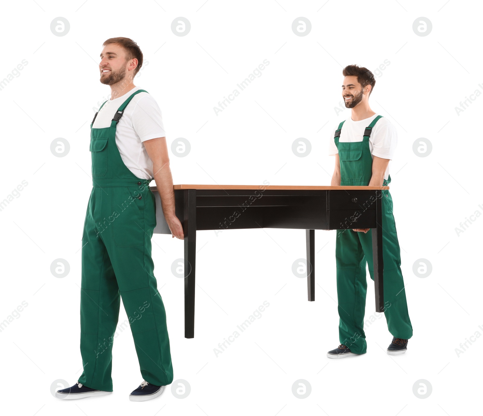 Photo of Young workers carrying table isolated on white. Moving service
