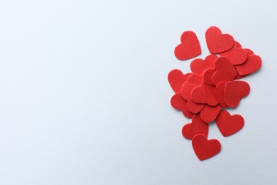 Paper hearts on white background, top view. Space for text