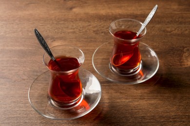 Glasses of traditional Turkish tea on wooden table