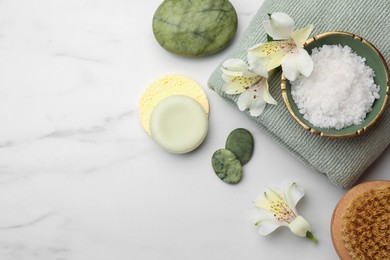Photo of Flat lay composition with spa products and flowers on white marble table. Space for text