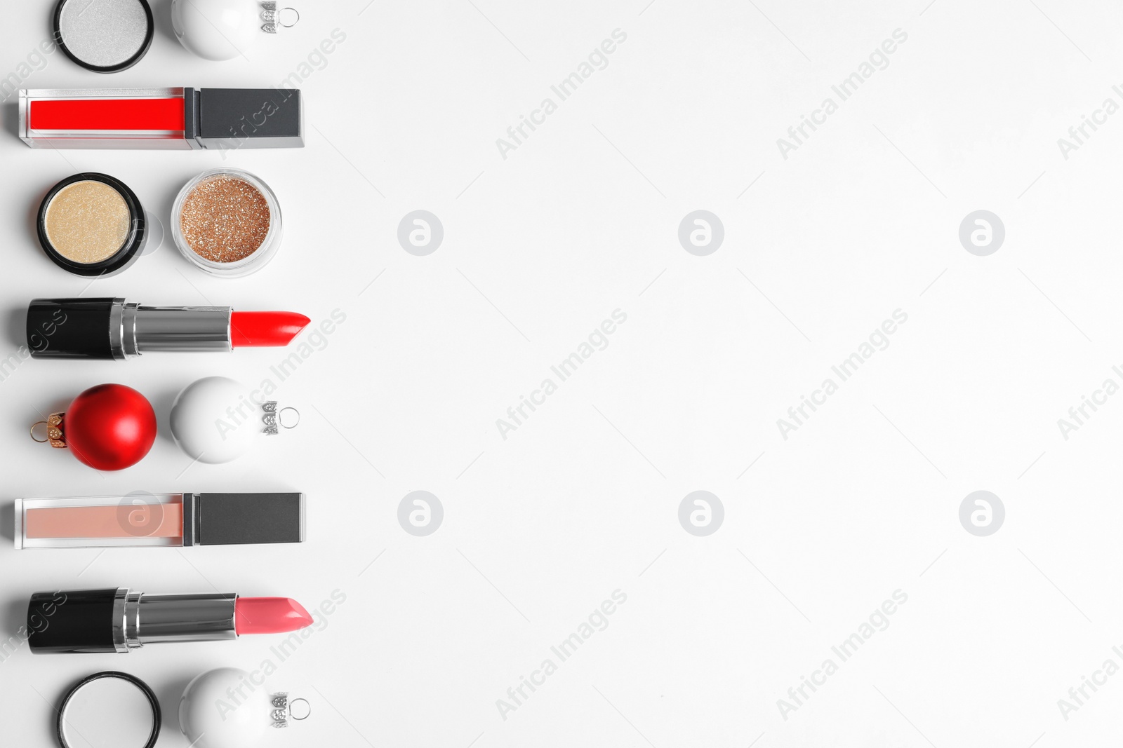 Photo of Flat lay composition with makeup products and Christmas decor on white background. Space for text