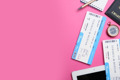Flat lay composition with tickets on pink background, space for text. Travel agency concept