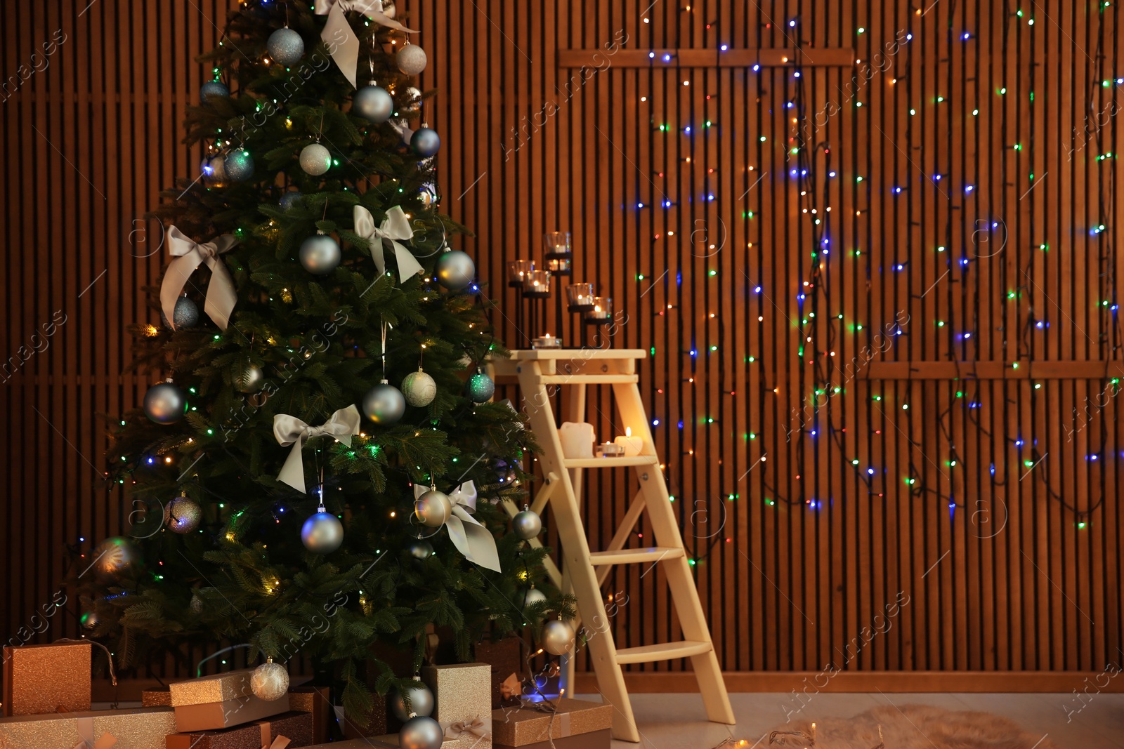 Photo of Stylish room interior with decorated Christmas tree