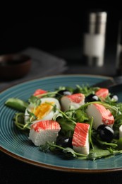 Photo of Delicious crab stick salad on blue plate, closeup