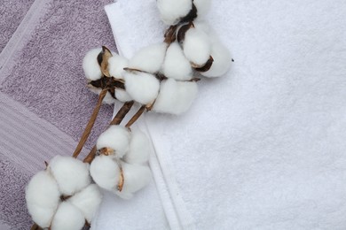 Cotton flowers on different terry towels, top view