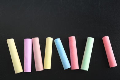 Color pieces of chalk on blackboard, top view