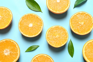 Flat lay composition with ripe oranges on color background