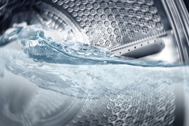 Washing machine drum with water, closeup view