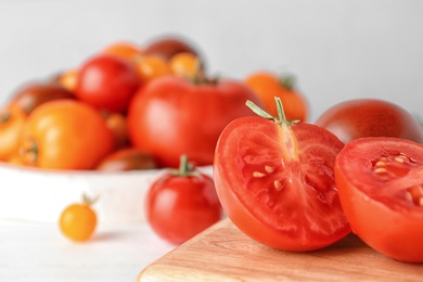 Fresh ripe tomatoes on wooden board, closeup. Space for text