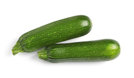 Photo of Raw ripe zucchinis on white background, top view