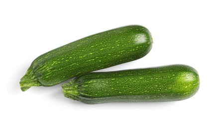 Raw ripe zucchinis on white background, top view