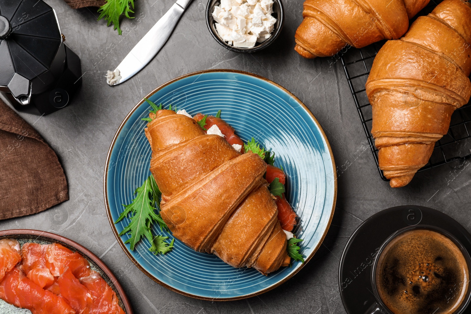 Photo of Flat lay composition with tasty croissant sandwich on grey table