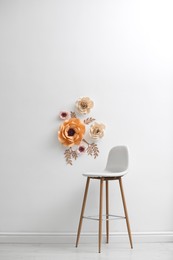 Photo of Stylish room interior with floral decor and bar stool