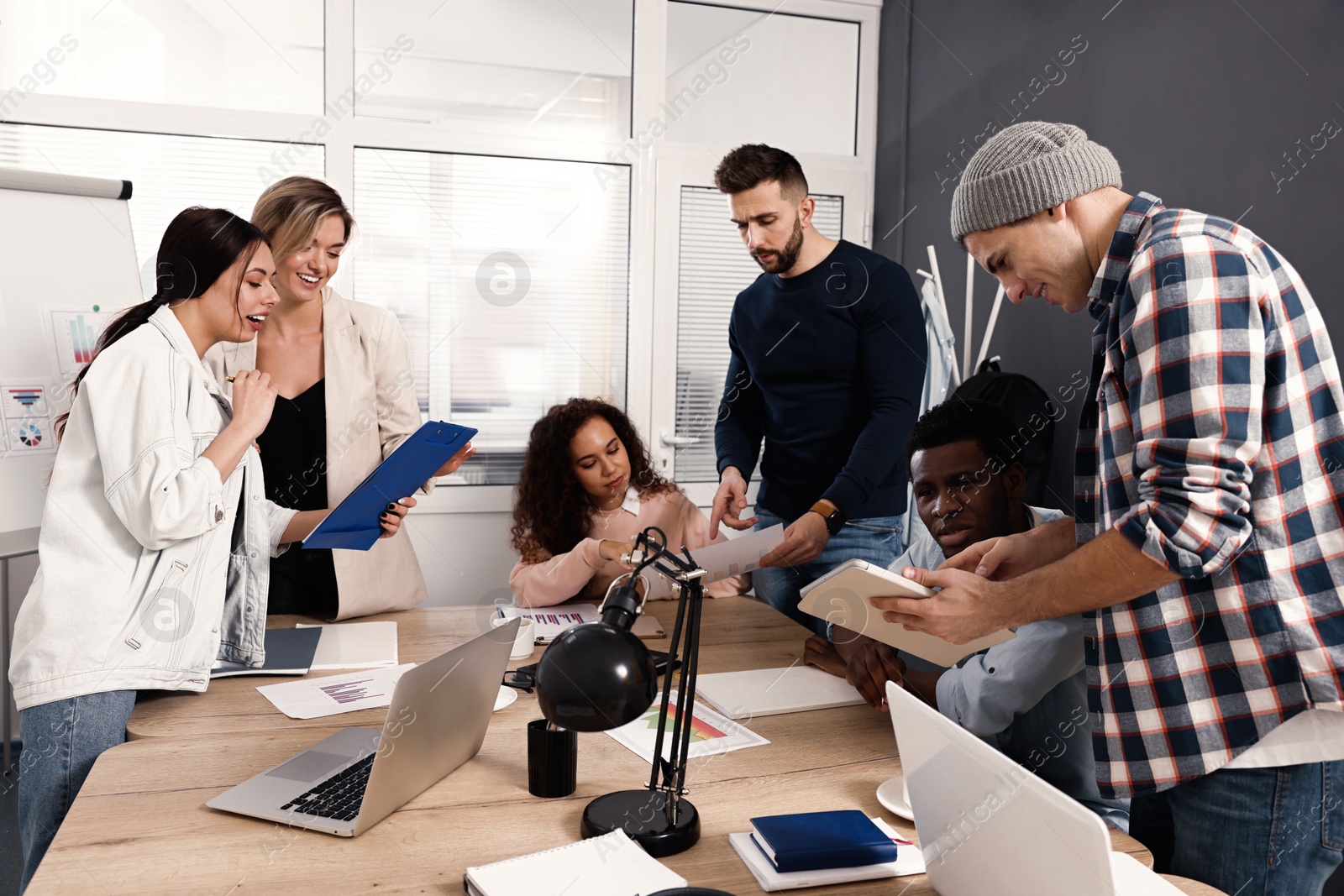 Photo of Team of employees working together in office. Startup project