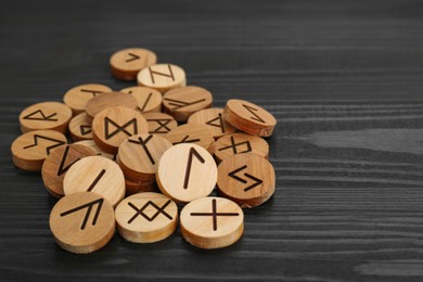 Pile of runes on black wooden table