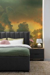 Image of Pattern of sunset sky with clouds on wallpaper indoors. Beautiful bedroom interior