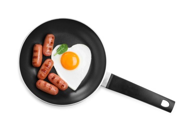 Romantic breakfast with fried sausages and heart shaped egg isolated on white, top view. Valentine's day celebration