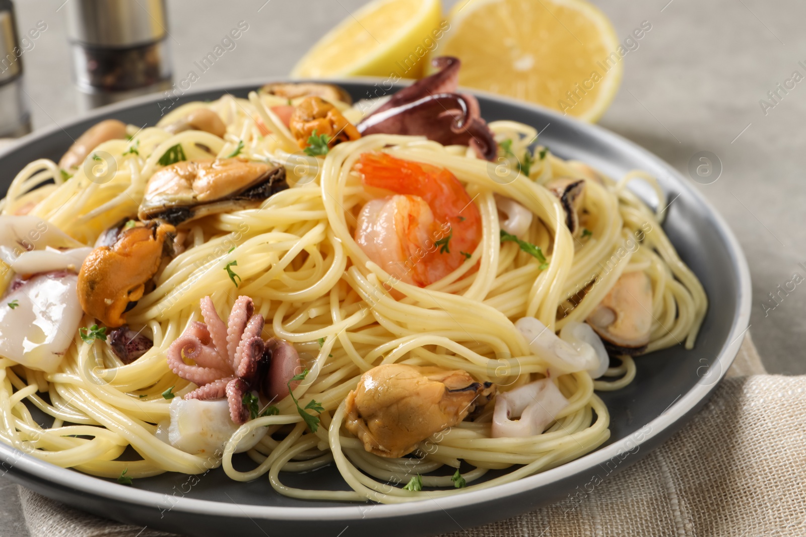 Photo of Delicious pasta with sea food on table, closeup