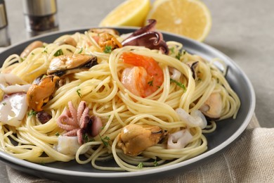 Photo of Delicious pasta with sea food on table, closeup