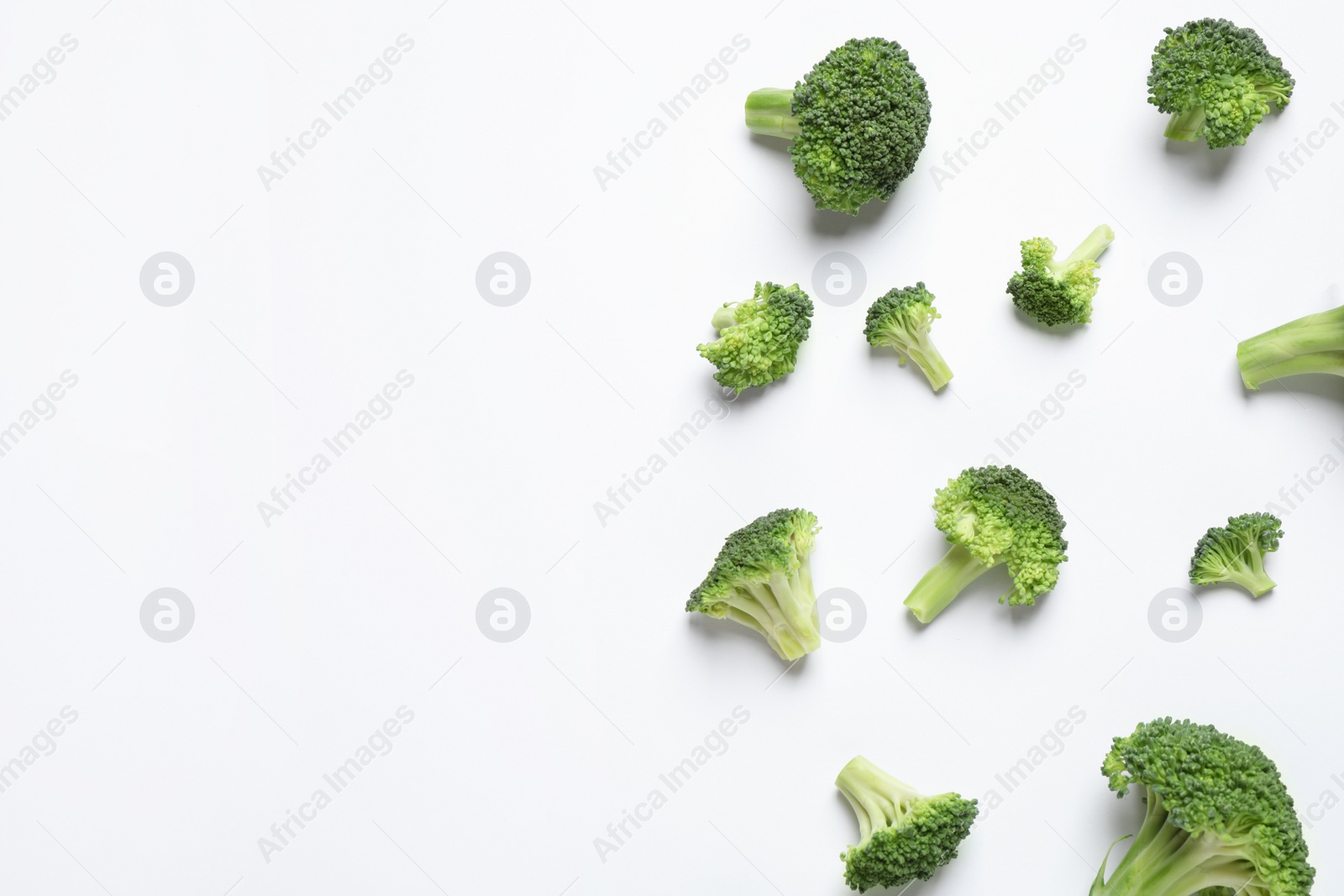 Photo of Fresh tasty broccoli on white background, top view