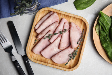 Photo of Tasty ham served on light grey marble table, flat lay