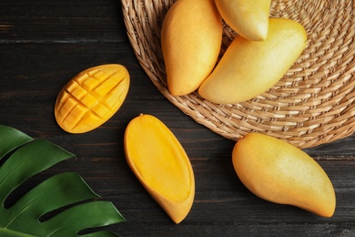 Photo of Flat lay composition with mango on wooden background