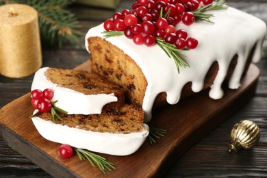 Traditional Christmas cake on black wooden table, closeup. Classic recipe