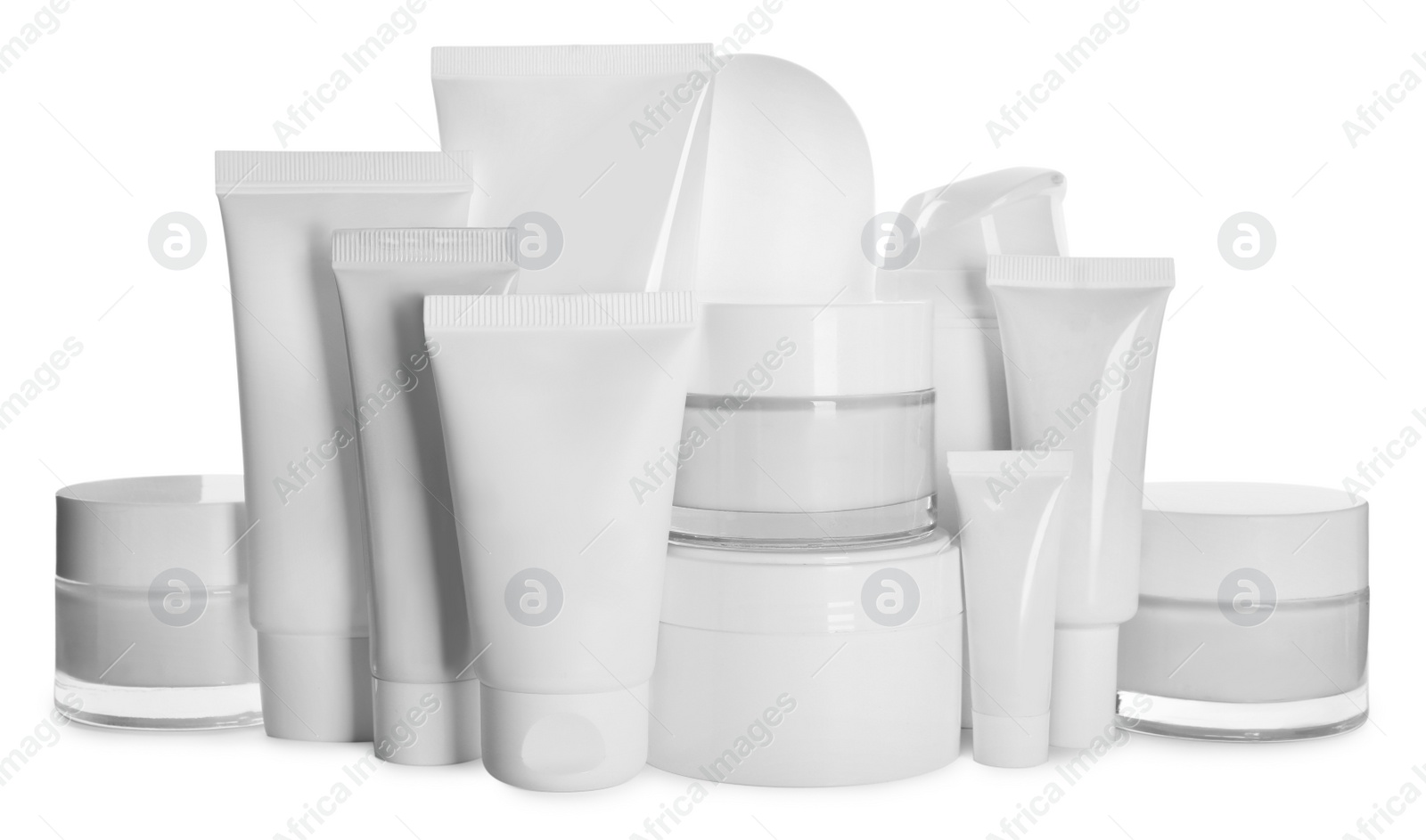 Photo of Blank tubes and jars of cosmetic products on white background