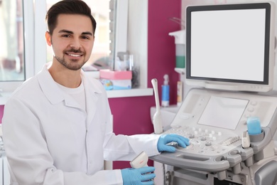 Sonographer using modern ultrasound machine in clinic