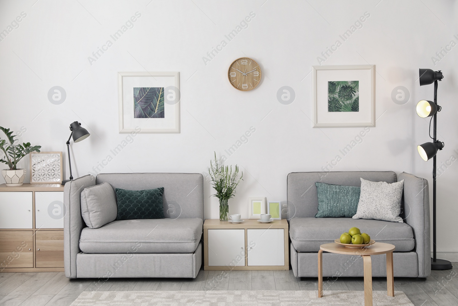 Photo of Modern interior of living room with comfortable armchairs near white wall