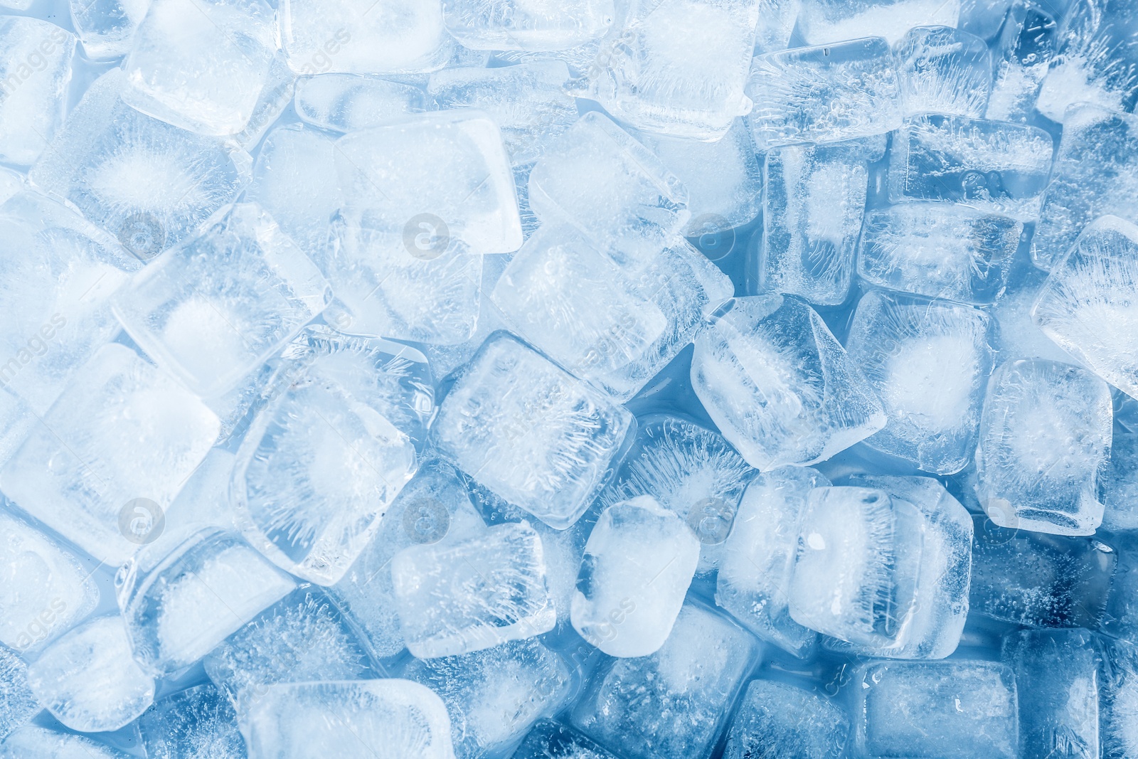 Photo of Crystal clear ice cubes as background, top view