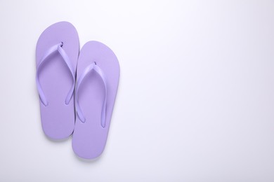 Stylish violet flip flops on white background, top view. Space for text