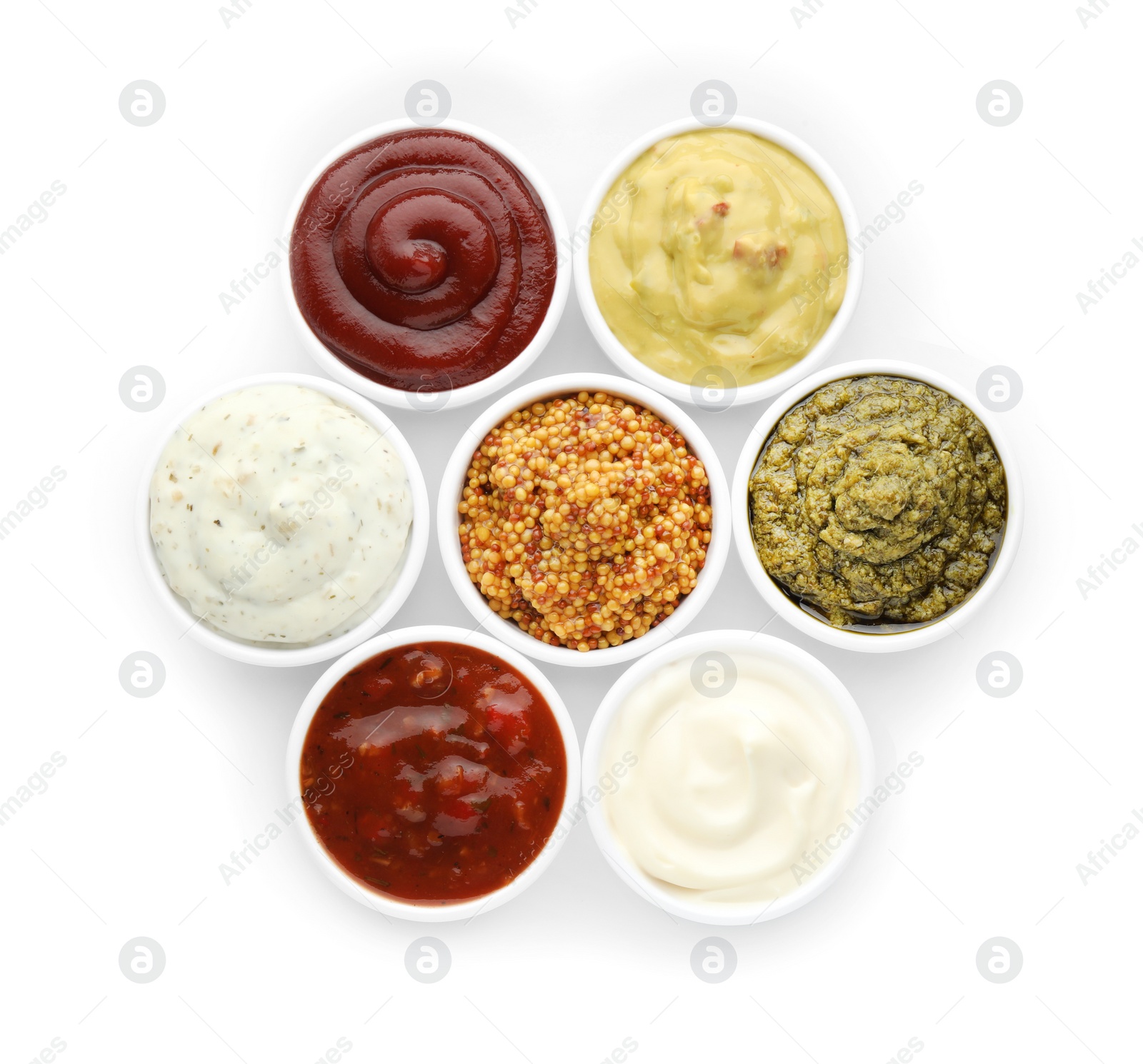 Photo of Many different sauces in bowls on white background, top view