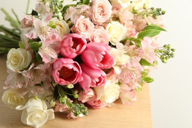 Photo of Beautiful bouquet of fresh flowers on wooden table, closeup