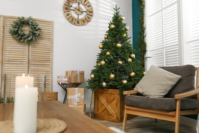 Photo of Beautiful decorated Christmas tree in living room interior