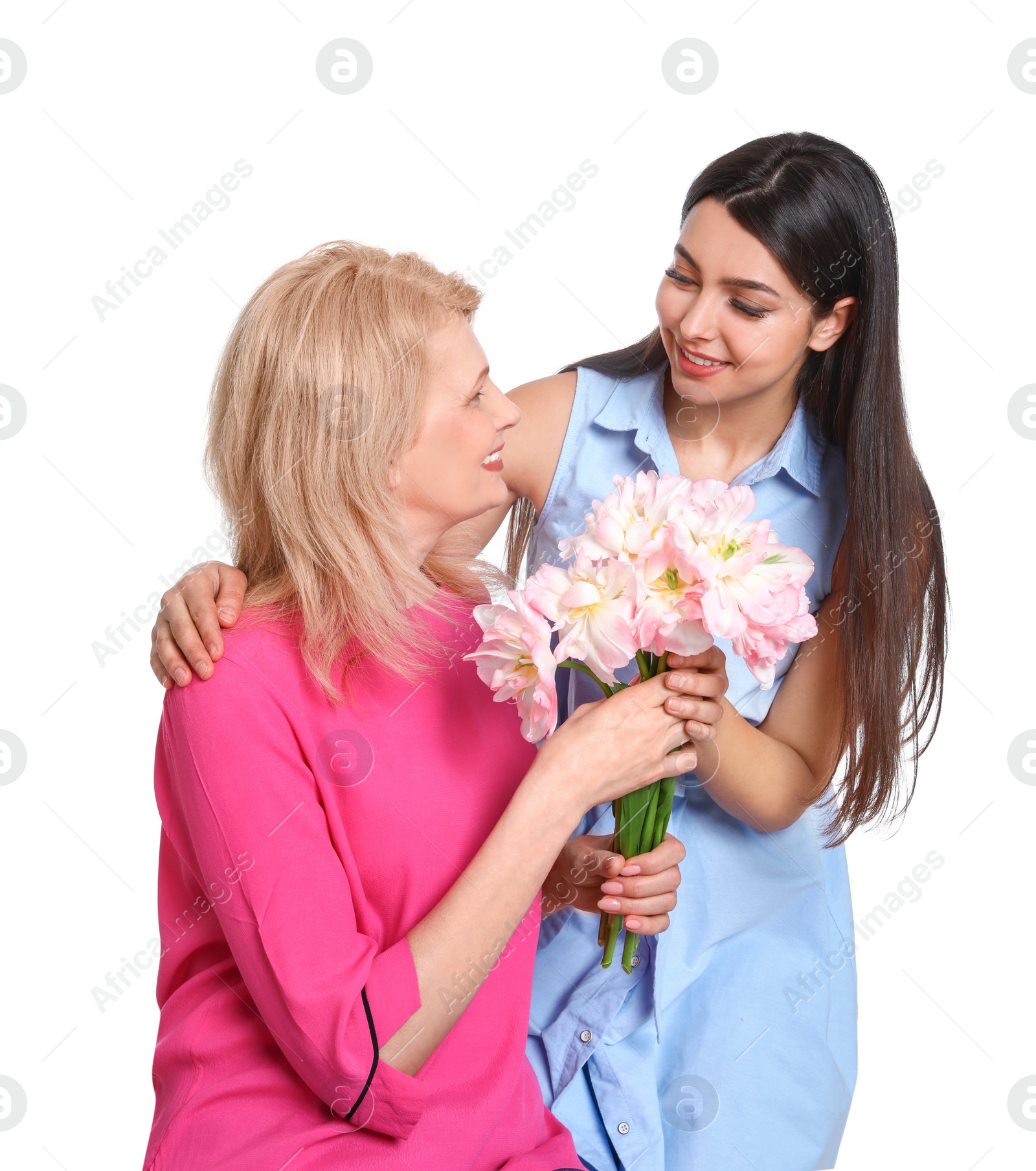 Photo of Young woman congratulating her mature mom on white background. Happy Mother's Day