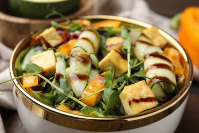 Delicious salad with tofu, vegetables and balsamic vinegar in bowl, closeup