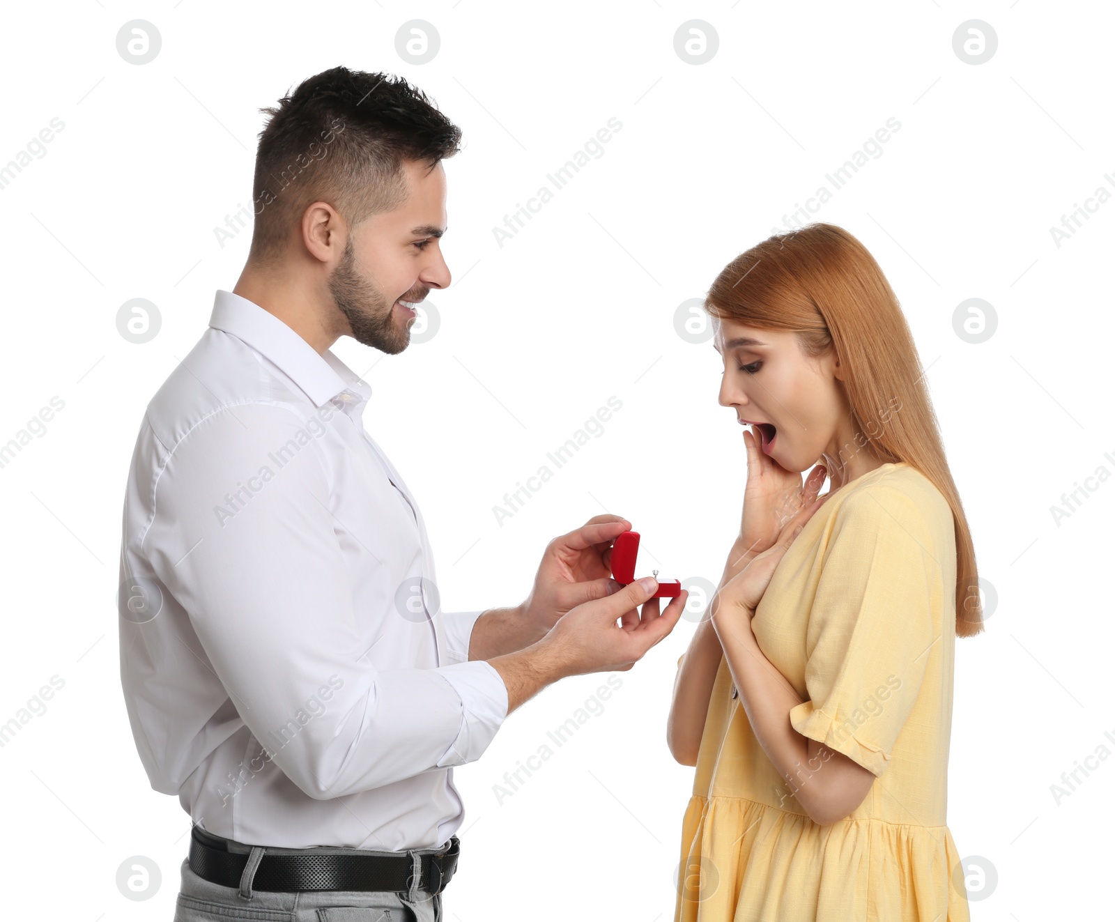 Photo of Man with engagement ring making marriage proposal to girlfriend on white background