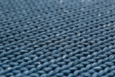 Photo of Beautiful pale blue knitted fabric as background, closeup