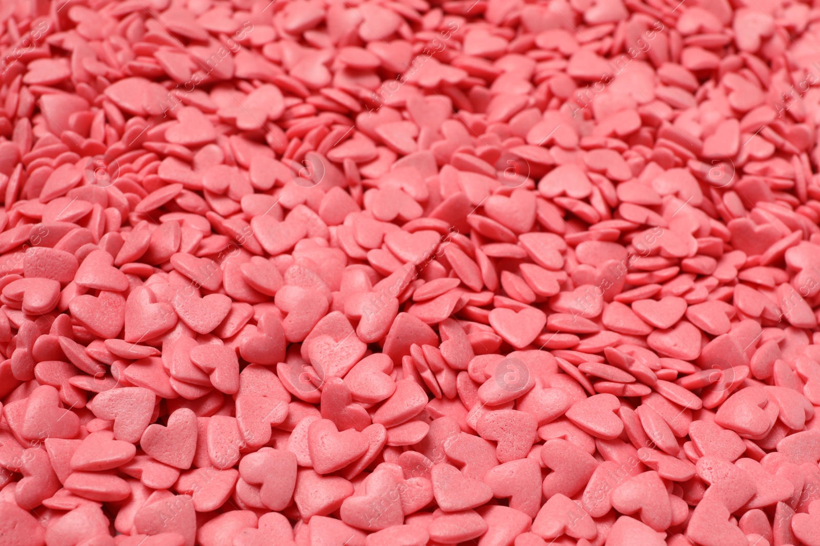 Photo of Sweet candy hearts as background, closeup view