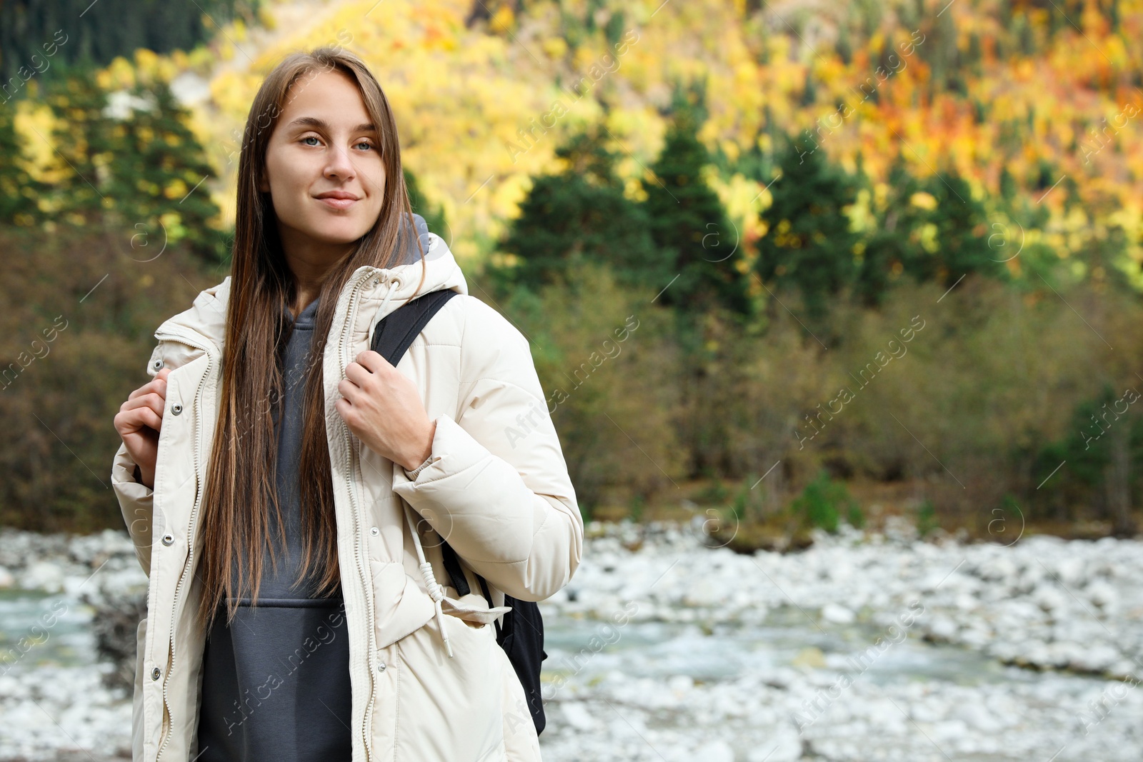 Photo of Woman with backpack in beautiful mountains. Space for text